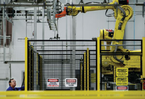 STRONG ARM An Electrolux employee  operates a robotic arm at the company’s new 750,000-square-foot manufacturing plant in Memphis.